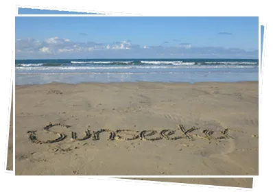 “Sunseeker” written in the sand on a Cornish beach